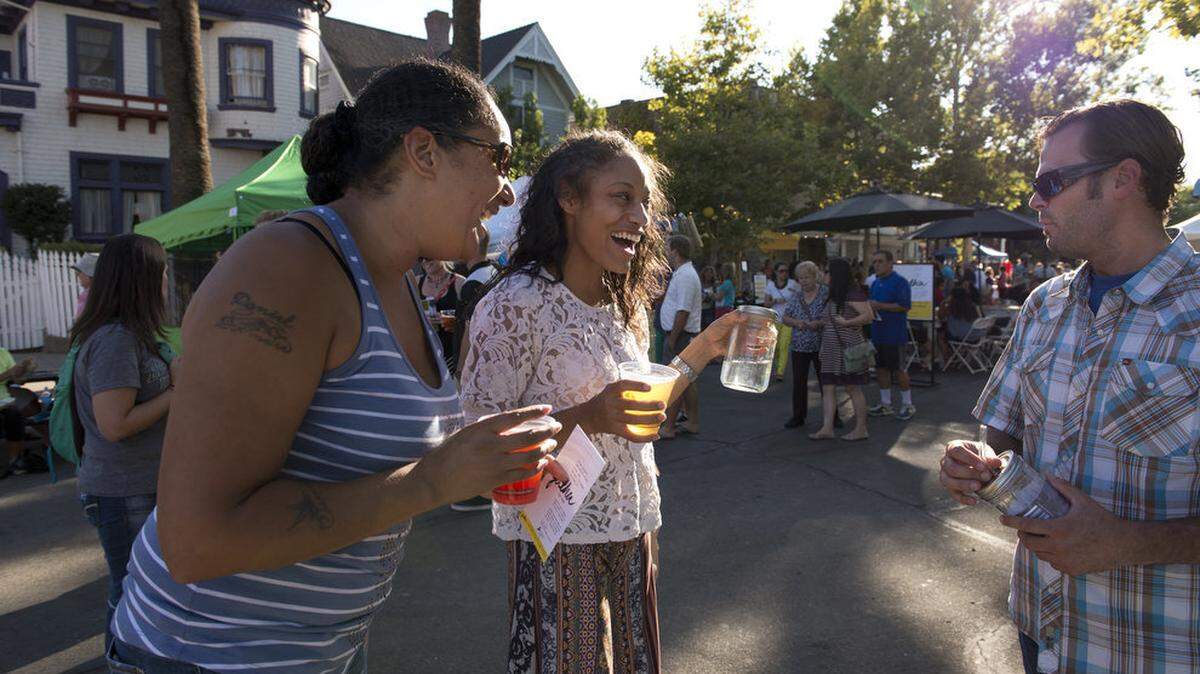 Cassandra Sharp, left and Kiara Reed of Oak Park sample juices from the Kombucha Kulture trailer from owner Joseph Melrose at Oak Park on Aug. 14, 2014. Kombucha is easy to make at home.