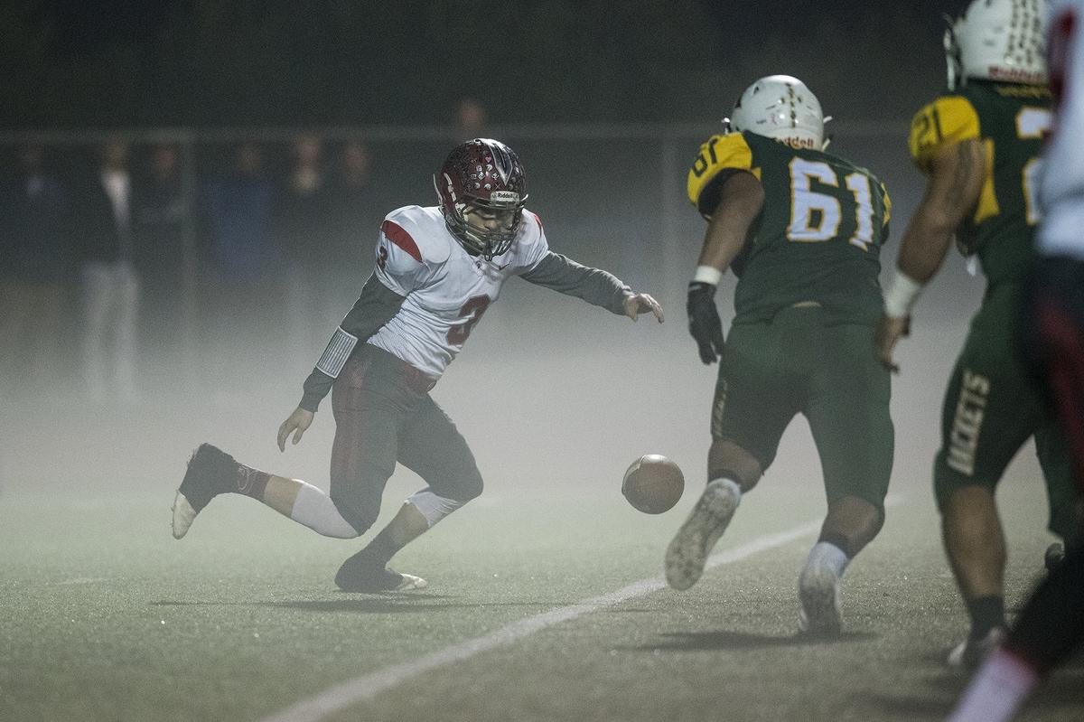 East Nicolaus senior Isidro Del Toro (3) fumbles the ball during the Northern California 6-AA Championship game against Hilmar at Atwater High School in Atwater, Calif., on Friday, Dec. 7, 2018. The Yellowjackets beat the Spartans 48-14.