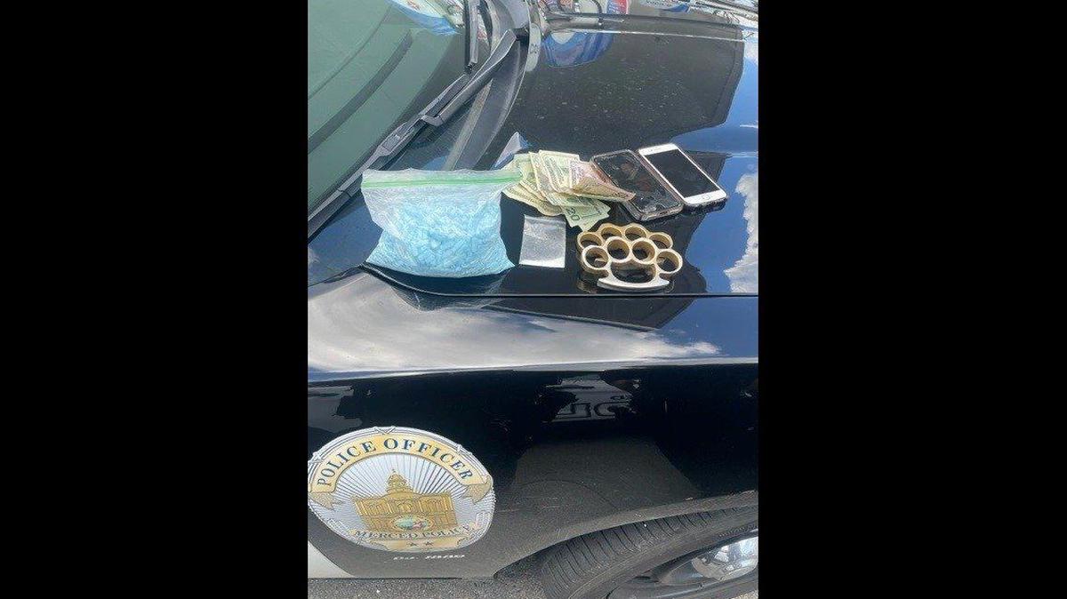A man and woman accused of traveling to Merced to sell narcotics, were arrested by officers in the 1900 block of East Childs Avenue on Wednesday, according to the Merced Police Department. Authorities said they located about 1,000 fentanyl pills, cocaine, metal knuckles and money. Image courtesy of Merced Police Department.