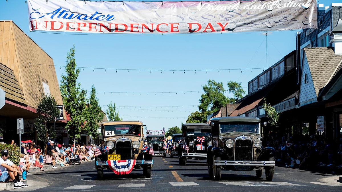 Vintage vehicles drive along Broadway Avenue during a Fourth of July parade in Atwater, Calif., on Monday, July 4, 2022.