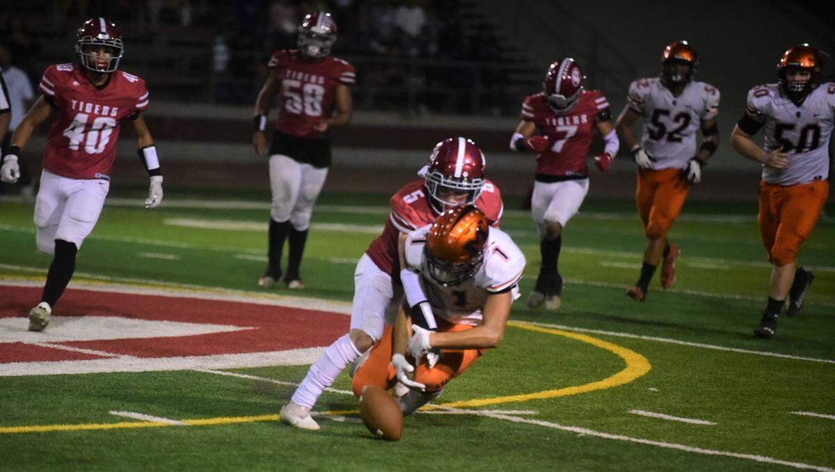 Patterson’s Jaydrian Lawson forces a fumble by punching the ball out of Merced’s Evahn Perez’s hands after a reception during a game at Patterson Community Stadium on Friday, Sept. 24, 2021.
