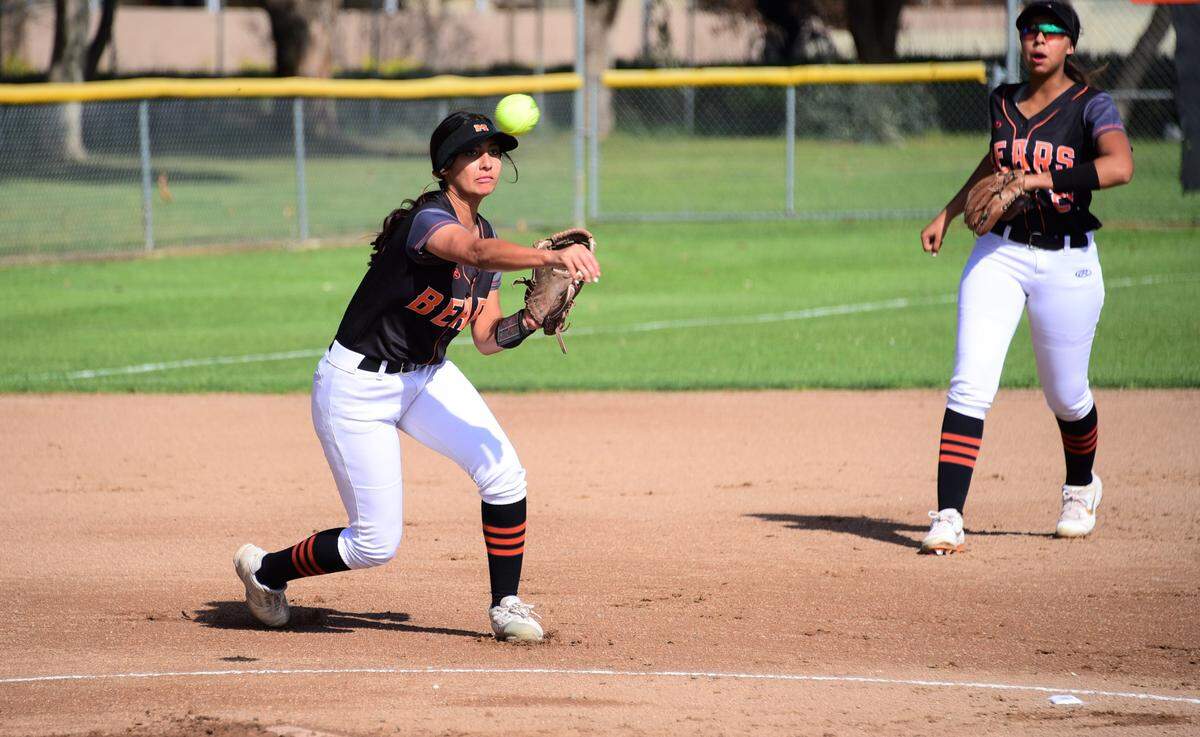 Merced High third baseman Elysa Walker makes a throw to first base to get an out in the first inning against Hughson on Wednesday, March 11, 2020 at Merced High School.