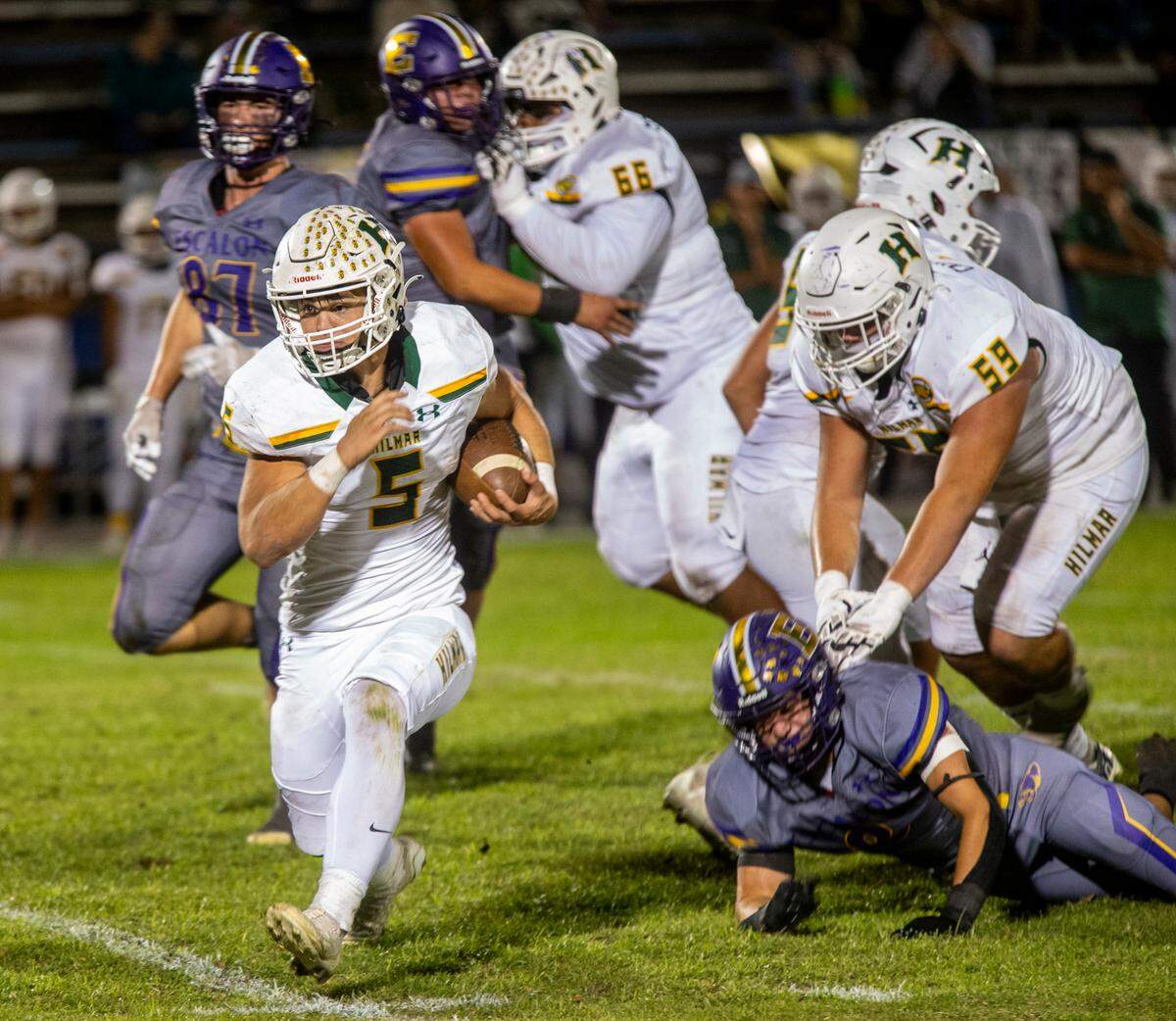 Caden Bailey, 9 of Hilmar High breaks through the Escalon High D-line during Friday Oct. 13, 2023 nights game at Modesto Jr. College.