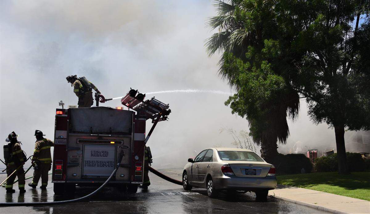 Merced Fire Department crews battled a fire that damaged two homes in Merced, Calif. on Friday, July 28, 2023.