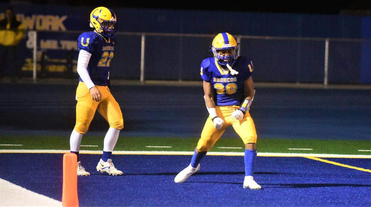 Dos Palos High School freshman running back Andre Flores (26) celebrates after scoring on a 44-yard touchdown run in a 28-27 playoff win over Morro Bay on Thursday, Nov. 19, 2022. Flores rushed for 253 yards and two touchdowns.