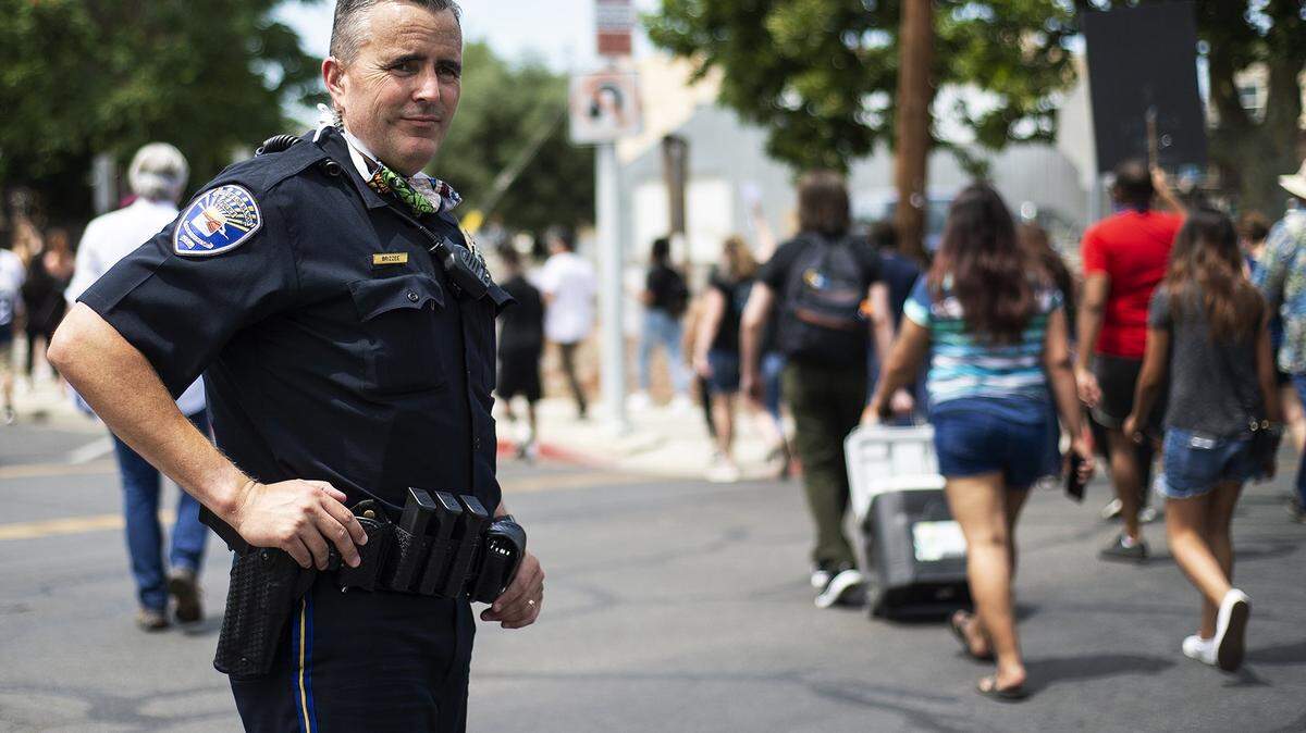 Los Banos Police Chief Gary Brizzee and other law enforcement officers stop traffic as people protest the recent police killing of George Floyd and police brutality in downtown Los Banos, Calif., on Tuesday, June 2, 2020. Floyd, an unarmed black man, died after being pinned down by a Minneapolis police officer.