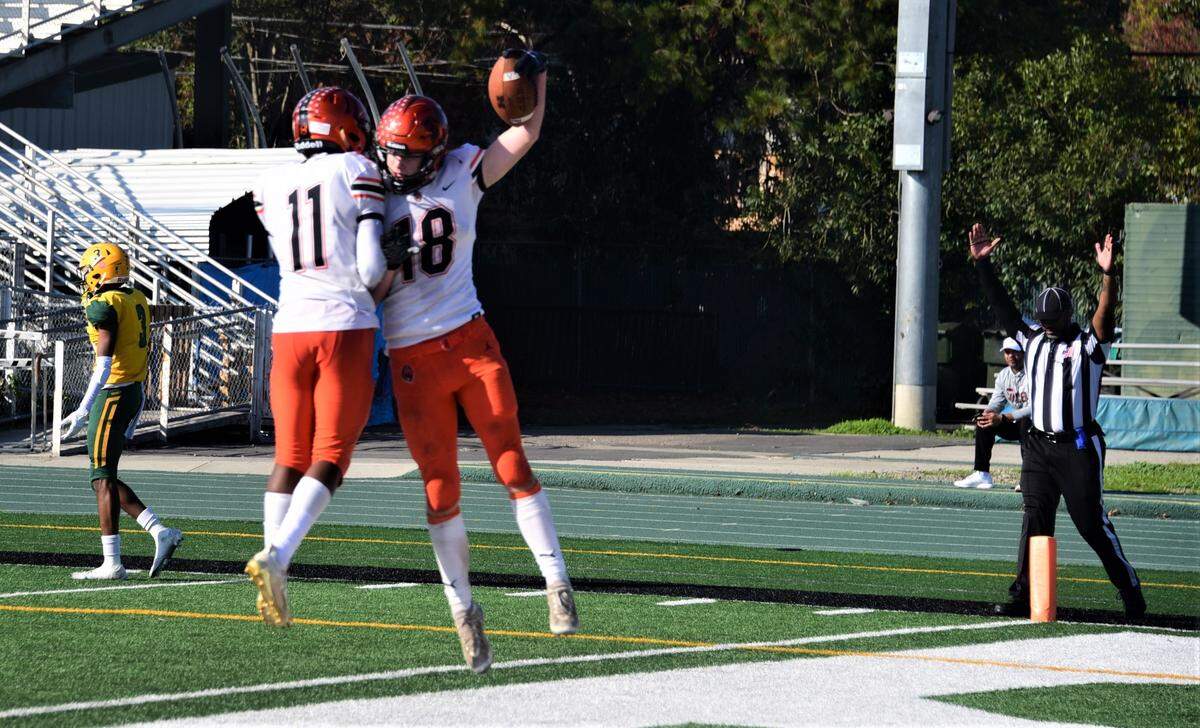 Merced High receiver Jack Collins (18) celebrates after scoring a touchdown with teammate Jaiden Davis during the first half of Merced’s 49-21 loss in the Sac-Joaquin Section Division IV championship game at St. Mary’s High School in Stockton, Calif. on Saturday, Nov. 27, 2021.