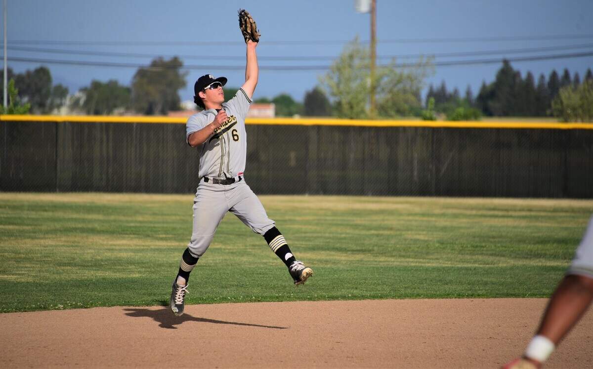 Buhach Colony High shortstop Cooper Lanz jumps up to snap a soft line drive for an out during a game against El Capitan on Friday, April 8, 2022 at El Capitan High School in Merced, Calif.