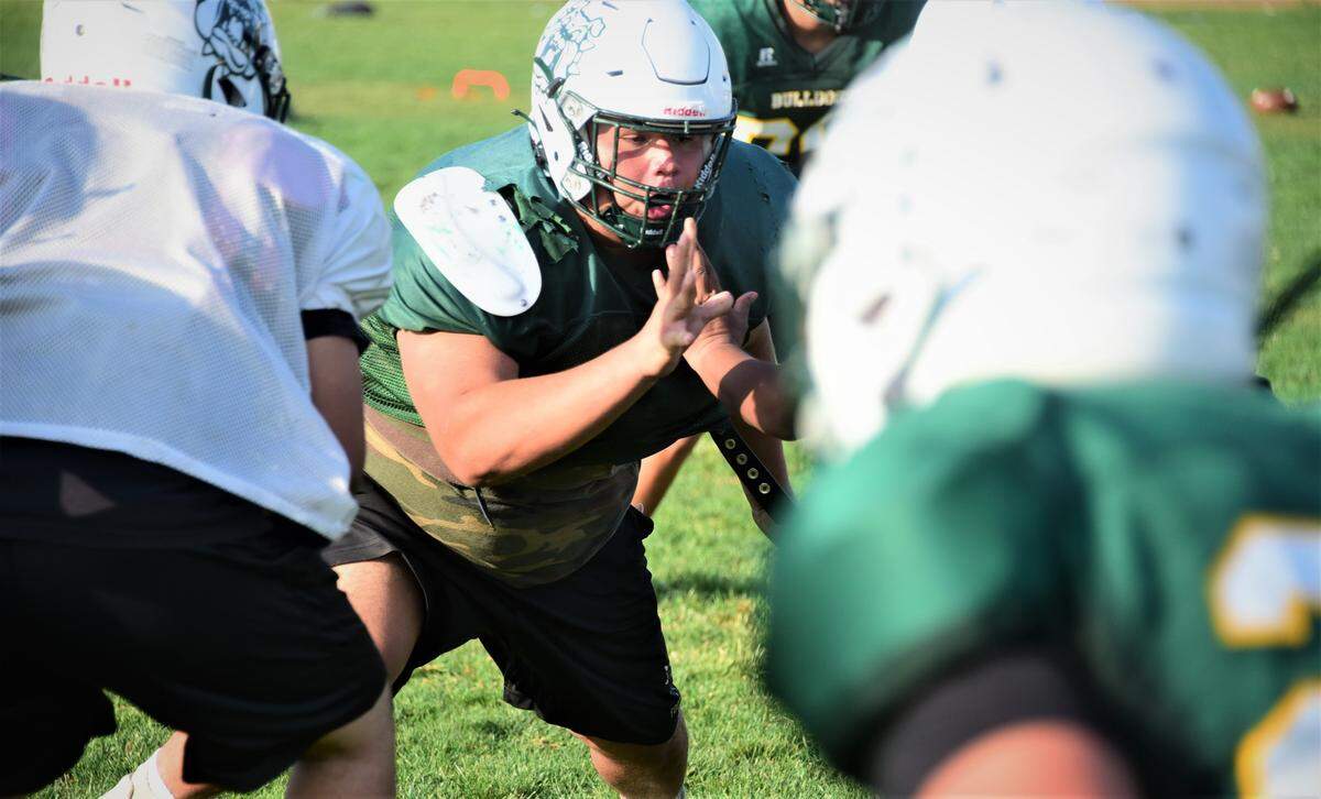 Le Grand High junior Fermin Villegas works through offensive plays during practice on Wednesday, Sept. 22, 2021 in Le Grand, Calif.