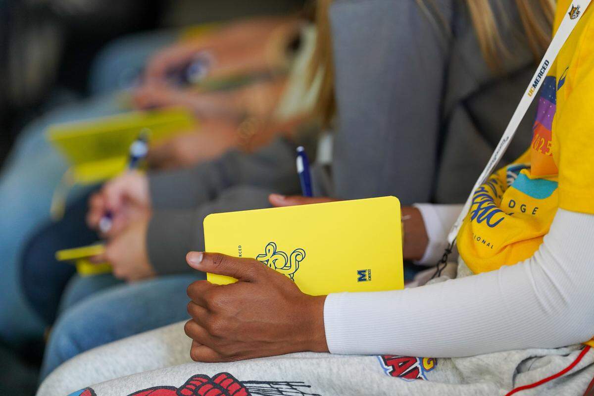 An attendee of the “Together We Will” conference at UC Merced takes notes on Sunday, March 8, 2026.