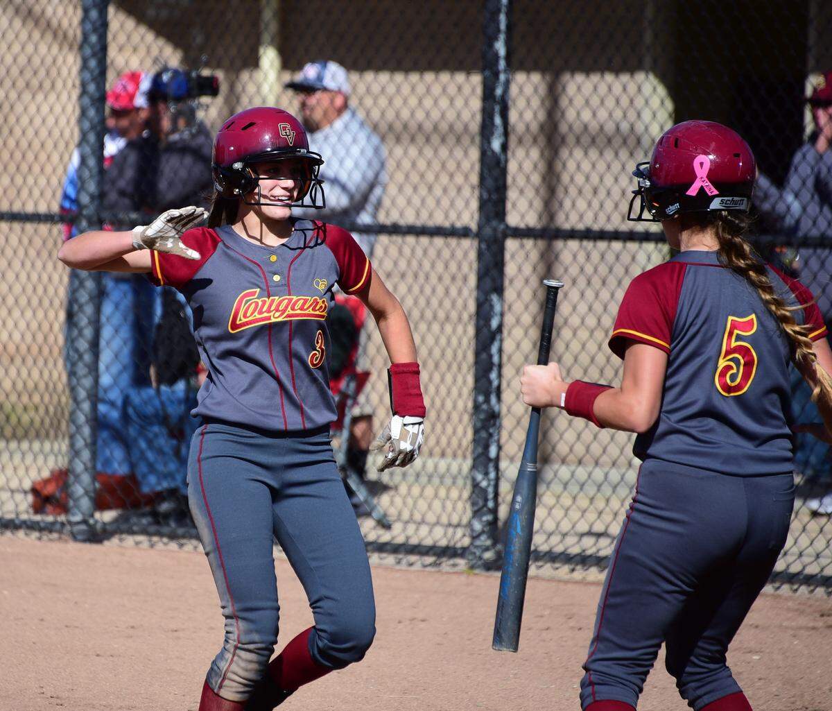 Golden Valley’s Marissa Bertuccio (left) celebrates after scoring a run with teammate Kylie Diaz during the first inning of the Cougars’ 3-2 win over Del Campo in the playoffs on Tuesday, May 21, 2019.