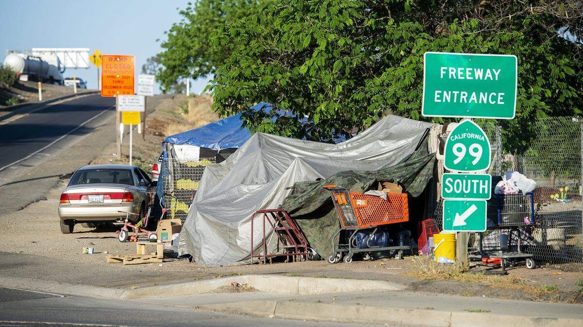 An encampment is seen along the Highway 99 south on-ramp off of G Street in Merced, Calif., on Thursday, May 6, 2021.