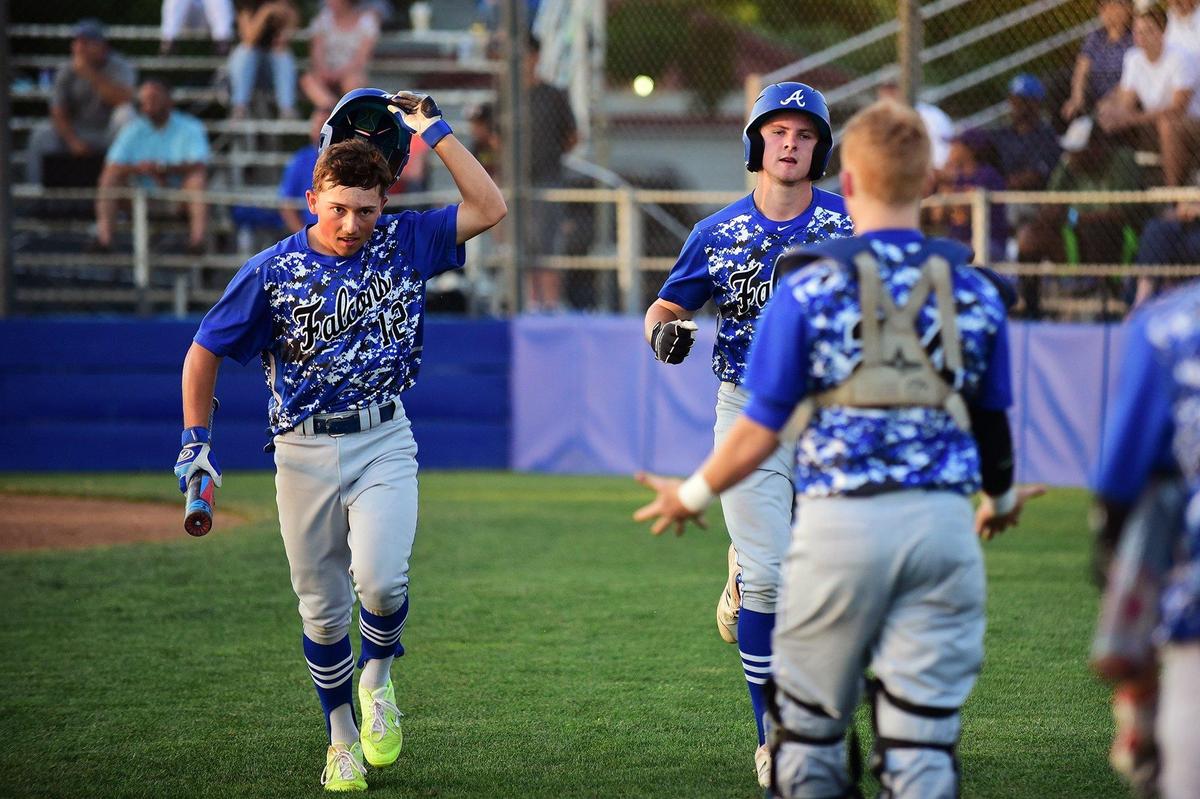 Atwater juniors Nathaniel Silva (12) and Jacob Weiss (9) are greeted by teammates as they jog back to the dugout during the championship game against Mountain House in the annual Fran Oneto/Atwater-Winton Lions Easter Baseball Tournament at Memorial Ballpark in Atwater, Calif., on Thursday, April 25, 2019. The Falcons beat the Mustangs 8-1.