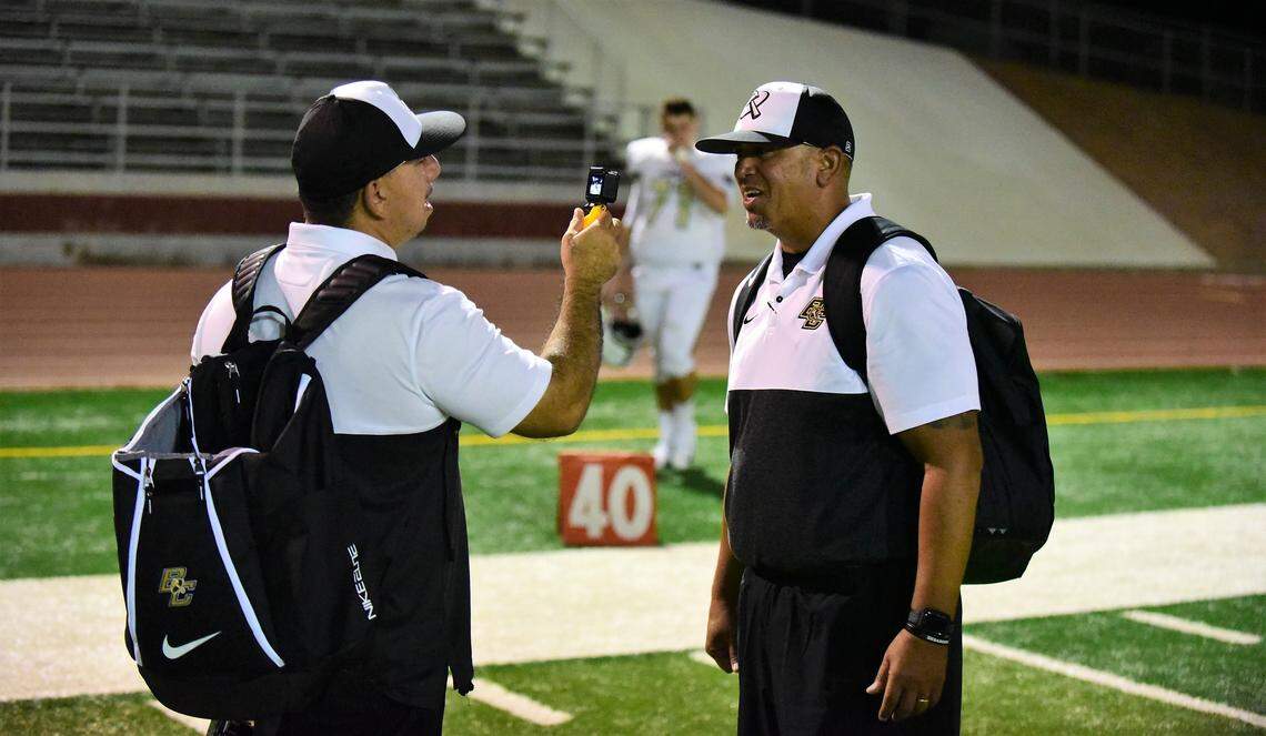 Keith Ducey, left, interviews Buhach Colony coach Kevin Navarra after the Thunder defeated Patterson 37-21 on Friday, Sept. 20, 2019 at Patterson High.