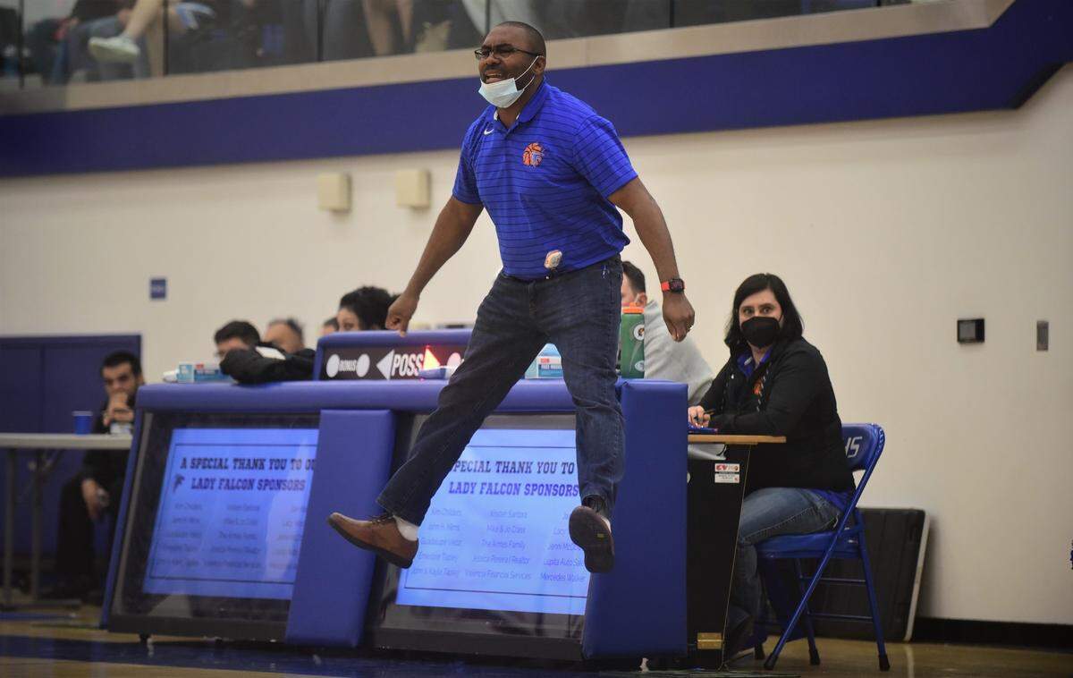 Atwater High girls basketball coach JR Davis leaps in the air as he coaches the Falcons during their game against El Capitan on Thursday, Feb. 3, 2022 at Atwater High School in Atwater, Calif.