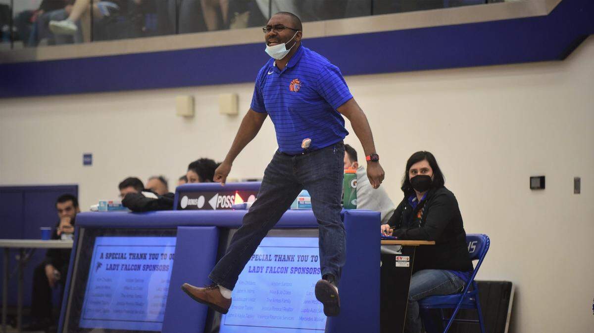 Atwater High girls basketball coach JR Davis leaps in the air as he coaches the Falcons during their game against El Capitan on Thursday, Feb. 3, 2022 at Atwater High School in Atwater, Calif.