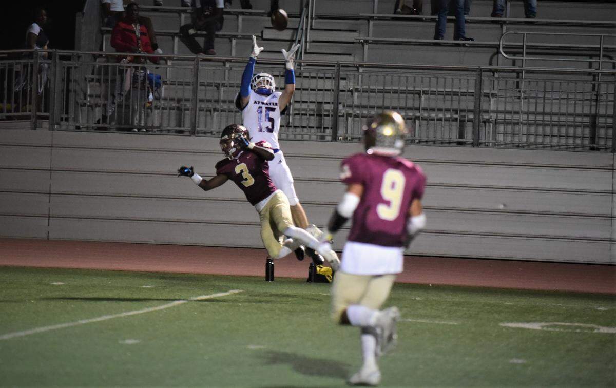 Atwater High receiver Colton Dukes (15) jumps up to haul in a 31-yard touchdown pass over Golden Valley defensive back Jonah White during a game on Friday, Oct. 7, 2022 at Veterans Stadium in Merced, Calif.