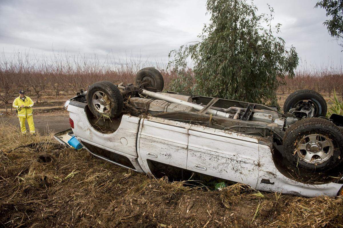 The California Highway Patrol and Riggs Ambulance service respond to the scene of a solo-vehicle collision on Gurr Road in Merced County, Calif., on Monday, Dec. 2, 2019. According to CHP Officer David Anderson, a 64-year-old Atwater woman was driving a Ford F-150 north on Gurr Road, south of Avenue Two, when for unknown reasons the truck drove onto the northbound shoulder. The driver overcorrected sending the truck across the southbound lane where it overturned onto the shoulder near a field, the CHP said. According to Anderson, the driver of the vehicle was not injured and crash. Slippery road conditions may have played a factor in the crash which is under investigation, according to authorities.