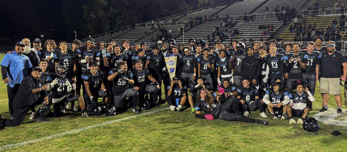 The El Capitan Gauchos pose with their CIF Sac-Joaquin Section Bowl championship banner after defeating Livingston 22-8 on Friday night at Stadium 76 at Merced College. The win marked El Capitan’s first victory over Livingston since 2015 and its first-ever game played in November.