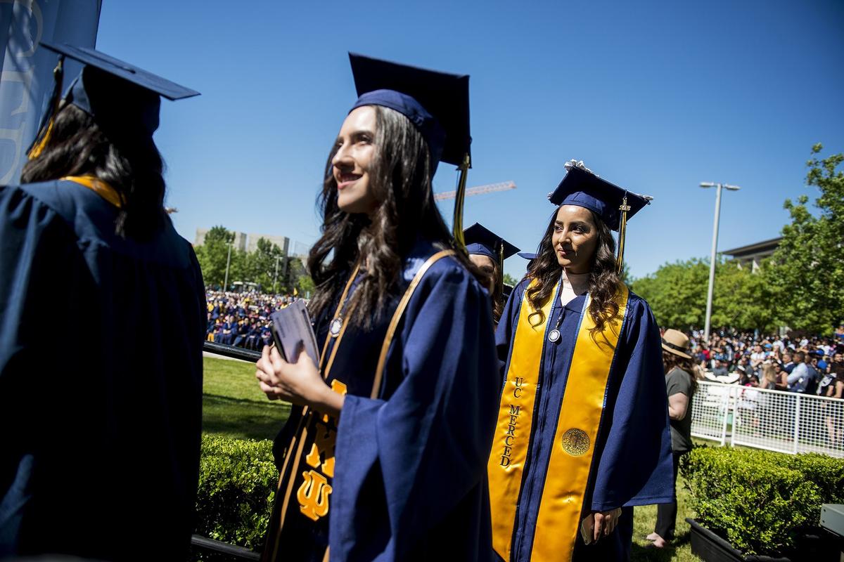 Graduates prepare to walk across the stage during the University of California, Merced School of Social Sciences, Humanities and Arts spring commencement in the Carol Tomlinson-Keasey Quad on the UC Merced campus in Merced, Calif., on Saturday, May 12, 2018.