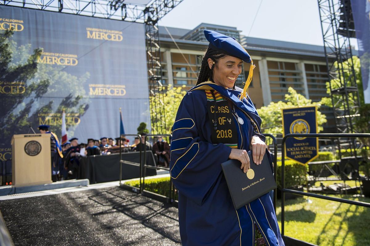 Maryam Crogman walks down the ramp after receiving her doctorate in child development and psychology, during the University of California, Merced School of Social Sciences, Humanities and Arts spring commencement in the Carol Tomlinson-Keasey Quad on the UC Merced campus in Merced, Calif., on Saturday, May 12, 2018.