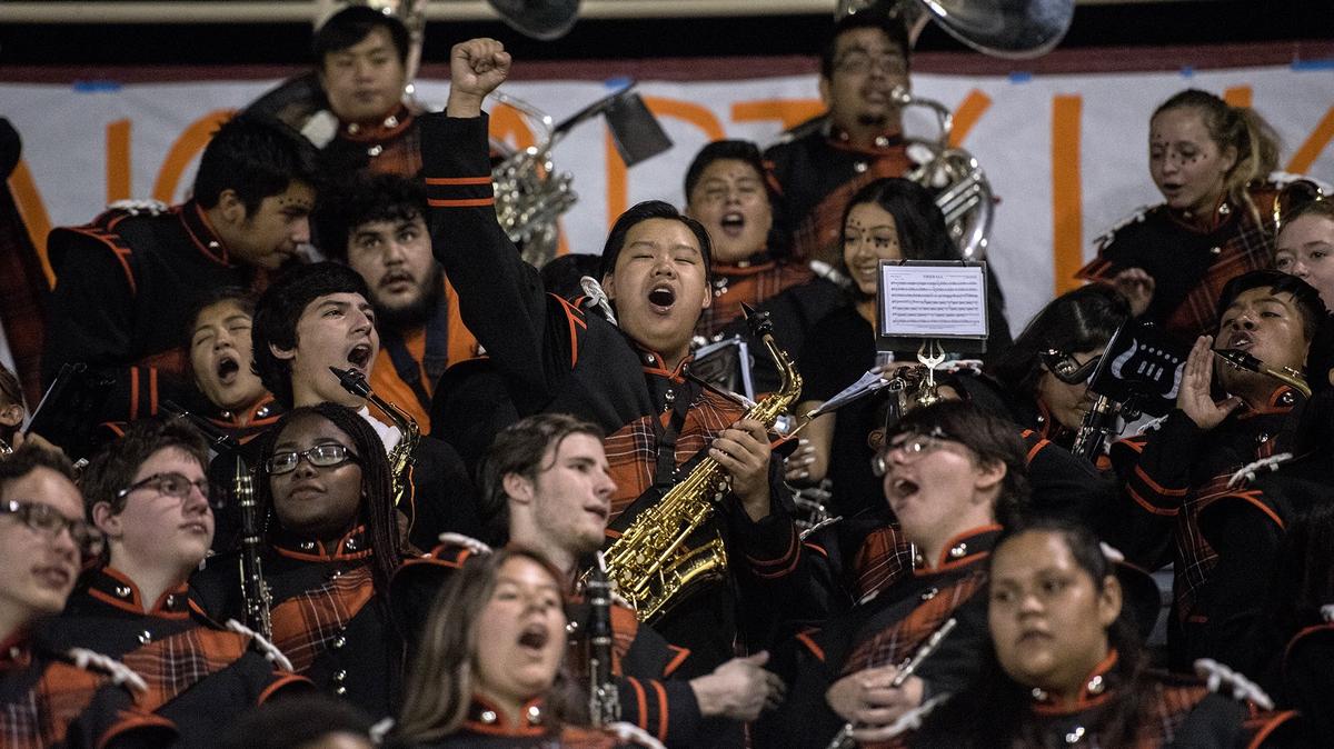 Merced senior William Moua, 17, cheers with the band as the Merced Bears play Madera at Veterans Stadium on the campus of Golden Valley High School in Merced, Calif., on Friday, Sept. 7, 2018. The Bears beat the Coyotes 63-35.
