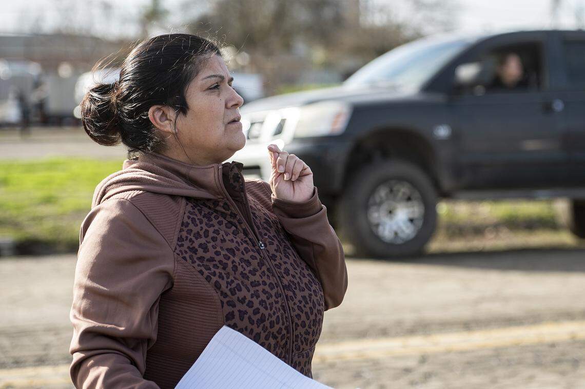 Saint Vincent De Paul Planada Sacred Heart Conference President, Alicia Rodriguez, assists residents affected by flooding in Planada, Calif., on Thursday, Jan. 12, 2023.