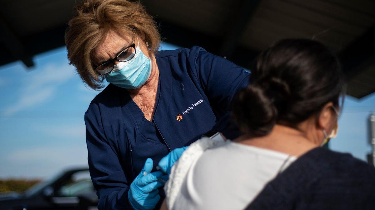 Registered Nurse Caren Col-Hamm administers a COVID-19 vaccine to a patient at the Bear Creek Apartments in Planada, Calif., on Thursday, Feb. 25, 2021. According to Planada Elementary School District Superintendent Jose Gonzalez, the district partnered with Dr. Sima Asadi to administer about 300 vaccines to residents involved in the agriculture and food industry.
