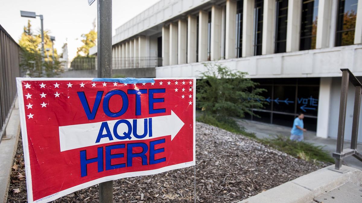 A “Vote Here” sign and tape on windows direct voters to the polls at the Merced County Library located at 2100 O Street in Merced, Calif., on Tuesday, Nov. 6, 2018.