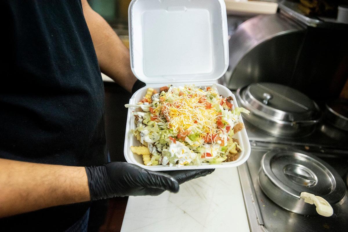 Chayanne Valencia, 33, prepares Asada fries at Maria’s Taco Shop in Merced, Calif., on Tuesday, Oct. 15, 2024. The restaurant which is open 24 hours, has offered authentic fast Mexican food to the Merced community for 32 years.