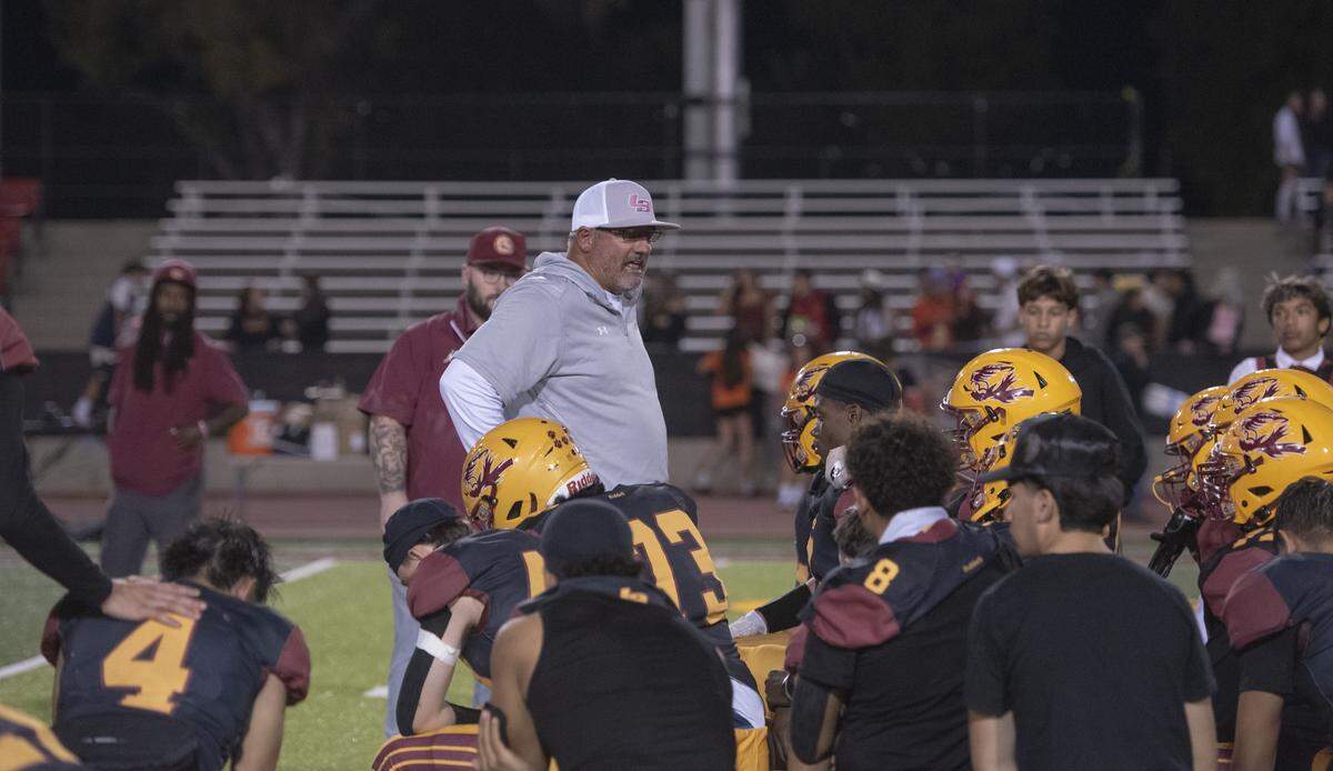 Los Banos head coach Dustin Caropreso talks with players after their game against Atwater. The Tigers saw a 13-point fourth-quarter lead slip away in the 35-34 loss.