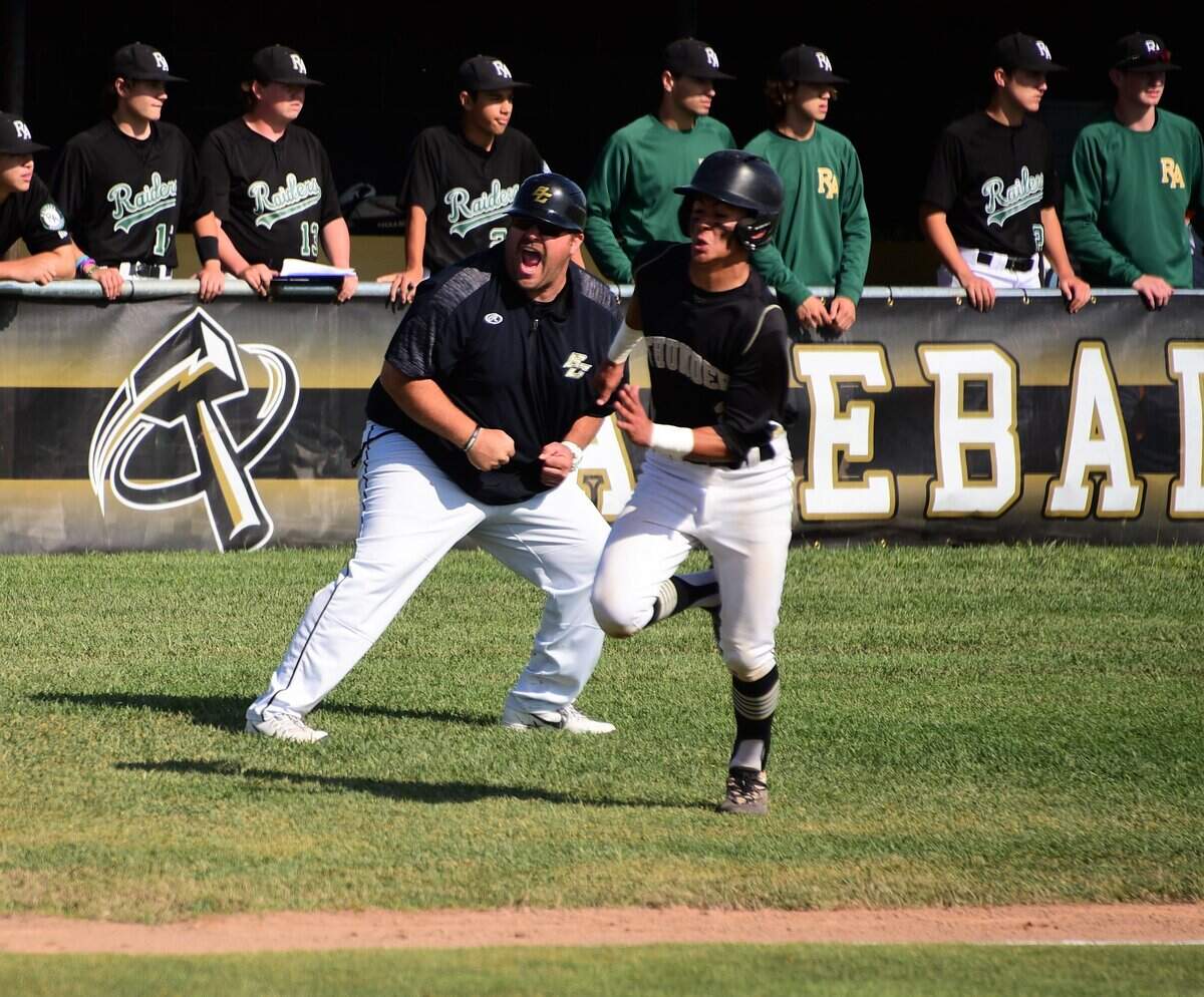 Buhach Colony’s Daniel Casso races home as third base coach Joe Medeiros reacts in the background. The Thunder advanced to the Final Four in the Sac-Joaquin Section Division III playoffs with a 6-2 win over Rio Americano on Friday, May 17, 2019.