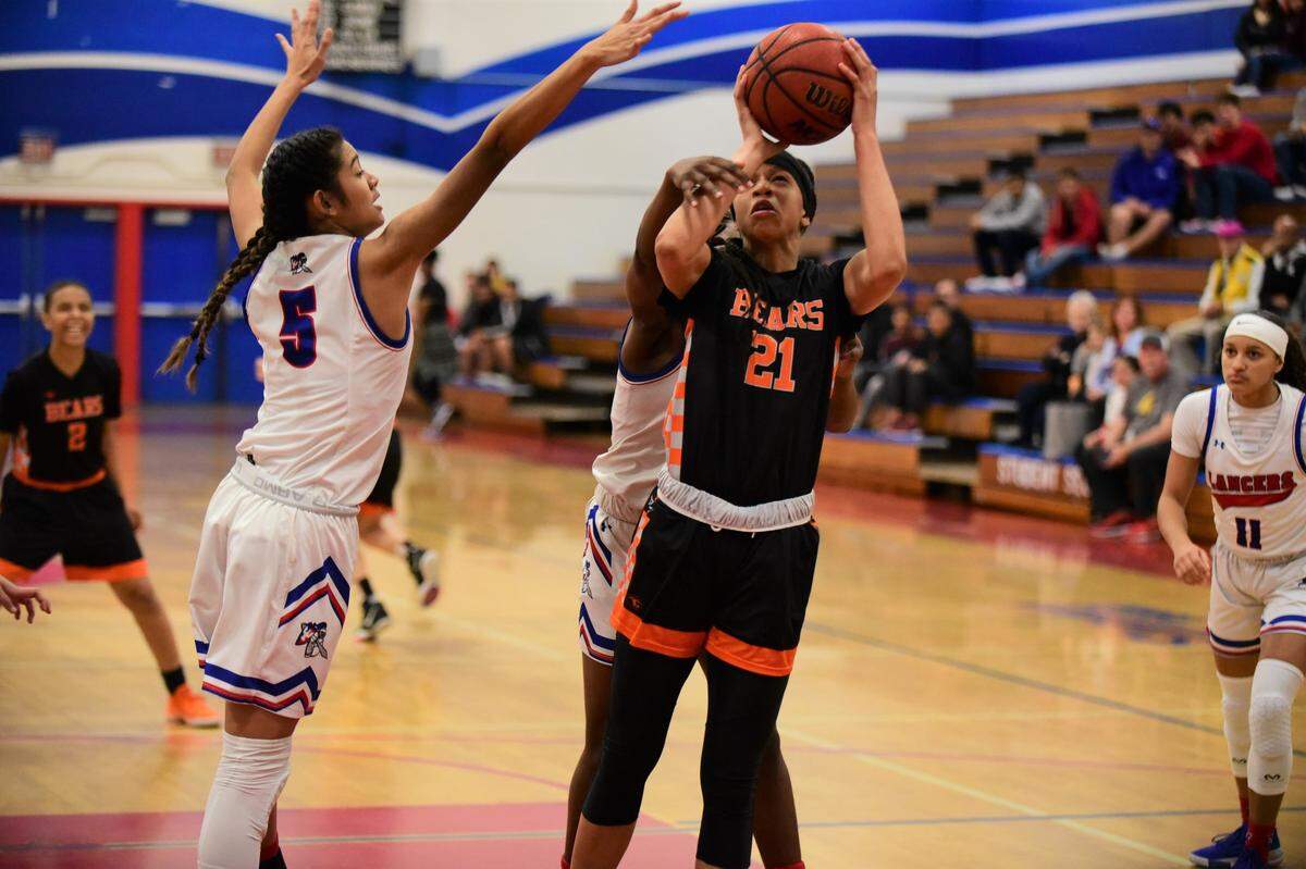 Merced High senior Khya Martin draws a foul as she goes up for a shot against East Union during a playoff game on Thursday, Feb. 20, 2020 at East Union High School in Manteca, Calif.