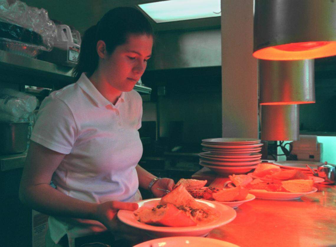 Katy Scott-Smith  18, a senior at McClatchy High School prepares to deliver meals to customers at Pete's Pizza in downtown Sacramento in 2001.