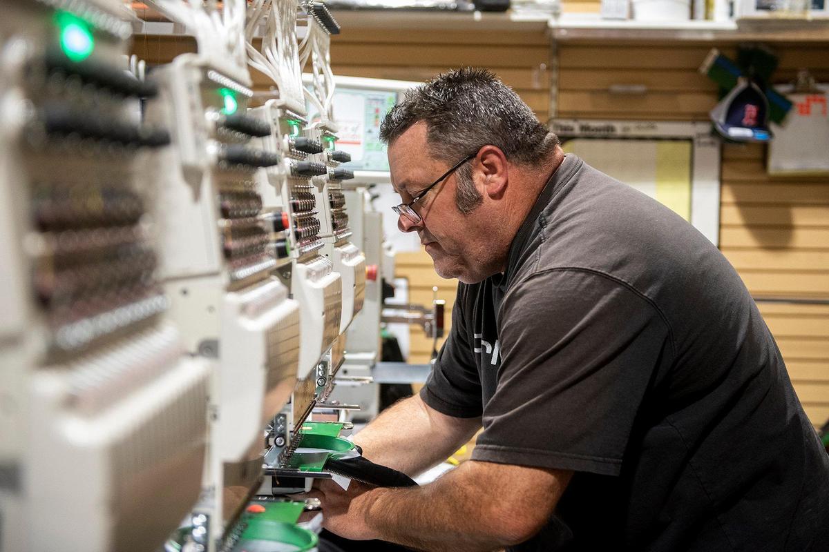 James Book, 53, of Merced, operates embroidery machines at McNamara Sports, located at 437 W. 18th Street in Merced, Calif., on Monday, May 8, 2023. The family owned store which sells athletic equipment, team uniforms, business apparel and offers screen printing and embroidery services, is celebrating 100 years in business