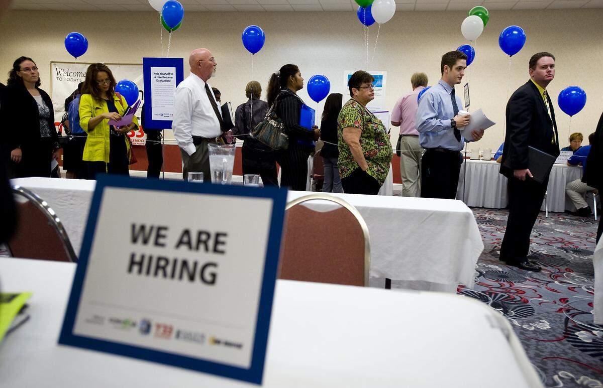 Job seekers wait in line at a job fair at the Holiday Inn Northeast in 2010 in Sacramento.