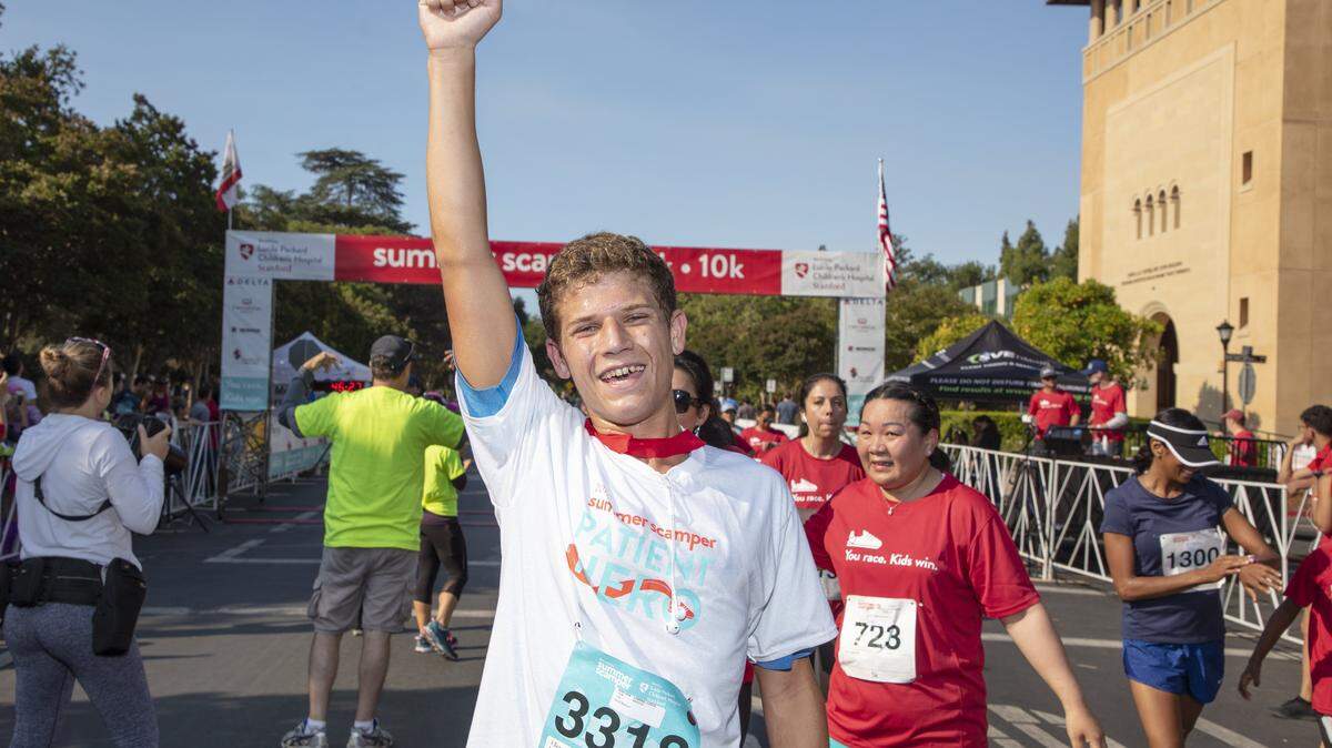 Lucca Lorenzi finishes the 10K run at the Summer Scamper in Palo Alto on Sunday, June 24, 2018. Lorenzi helped put together a donation of 800 art supply items to the Lucile Packard Children's Hospital Stanford last summer. Together with his family, he helped come up over $5,000 in donations for the Lucile Packard Foundation for Children's Health. Photo by Doug Peck courtesy of Lucile Packard Foundation for Children's Health.