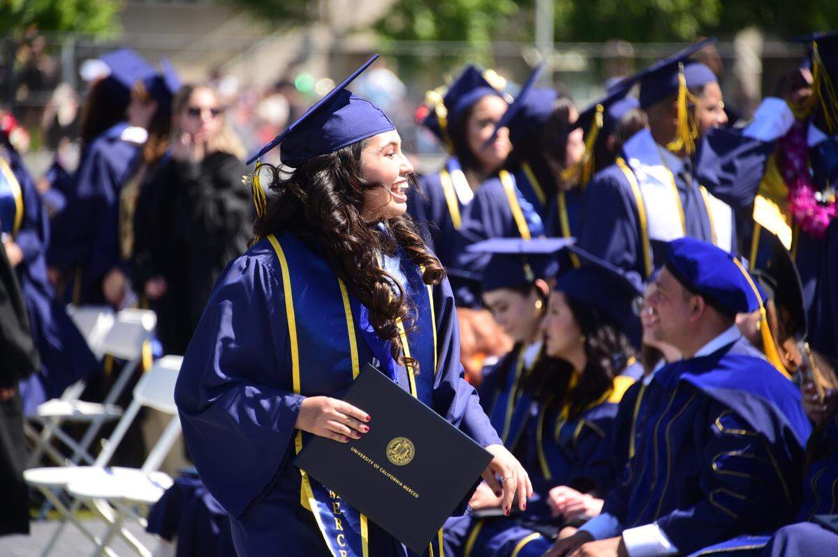 UC Merced graduate Cathryn Flores holds her diploma after walking off stage during the 2022 UC Merced Graduation Ceremony on Saturday, May 14, 2022 at UC Merced in Merced, Calif. 