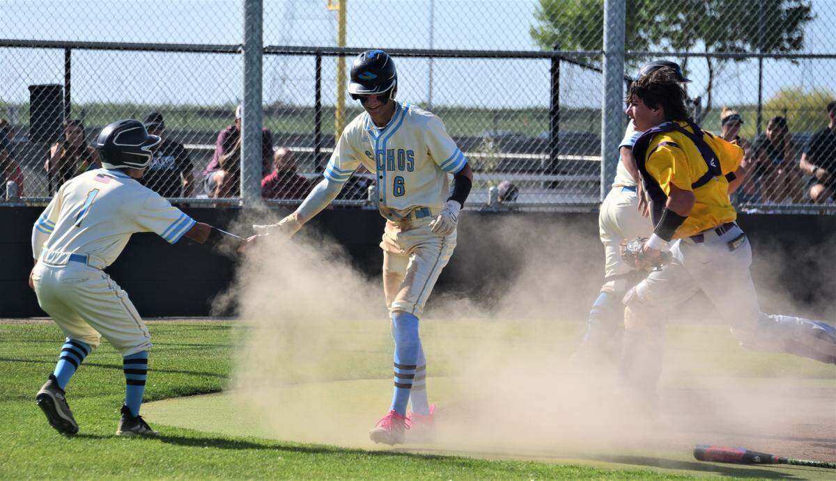 El Capitan High School junior Braden Giardina (6) celebrates with teammate Leo Martinez after scoring a run in the second inning of an 11-0 win over Escalon on Thursday, April 27, 2023 at El Capitan High School.