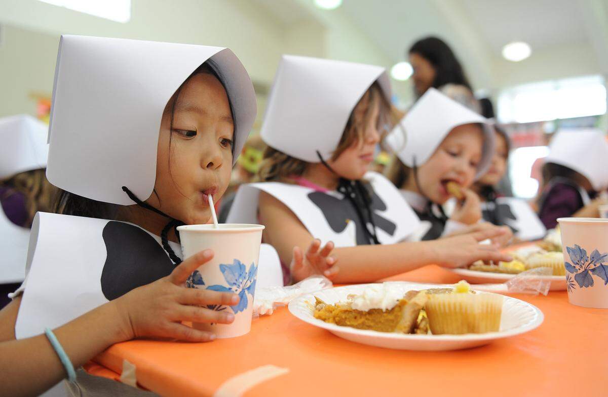 BEA AHBECK CASSON/bahbeck@mercedsunstar.comPeggy Heller School kindergardner Breena Vang, 5, enjoys her drink during the thanksgiving feast at the Atwater school Thursday. (11-15-12)