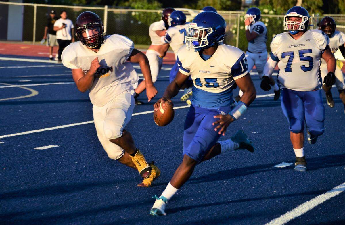 Atwater High School sophomore quarterback AJ Banks (15) runs the ball during a scrimmage against Edison of Stockton on Friday, Aug. 11, 2023 at Dave Honey Stadium in Atwater, Calif.