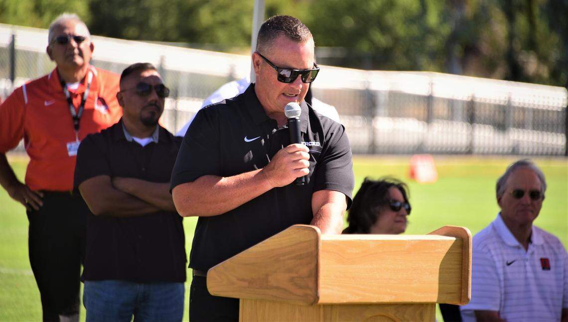 Merced High School football coach Rob Scheidt speaks during the ribbon-cutting ceremony for the school’s new on-campus Cathie Hostetler Stadium on Friday, Aug. 12, 2022.