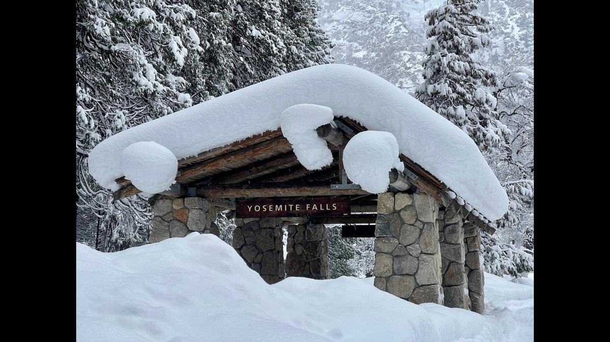 The bus shelter at the base of Yosemite Falls is nearly covered in snow. Yosemite National Park is closed to visitors after the park experienced significant snowfall with some areas recording up to 15 feet of snow, according to a Yosemite National Park Facebook post on Tuesday, Feb. 28, 2023. Image courtesy of Yosemite National Park.