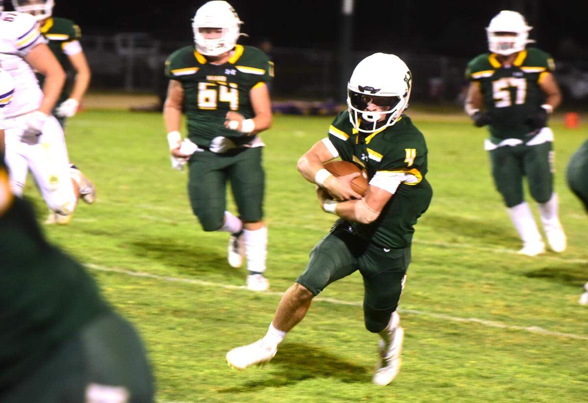 Hilmar High quarterback Merek Ellerd (4) runs the ball up field during a game against Escalon on Friday, Sept. 27, 2024.