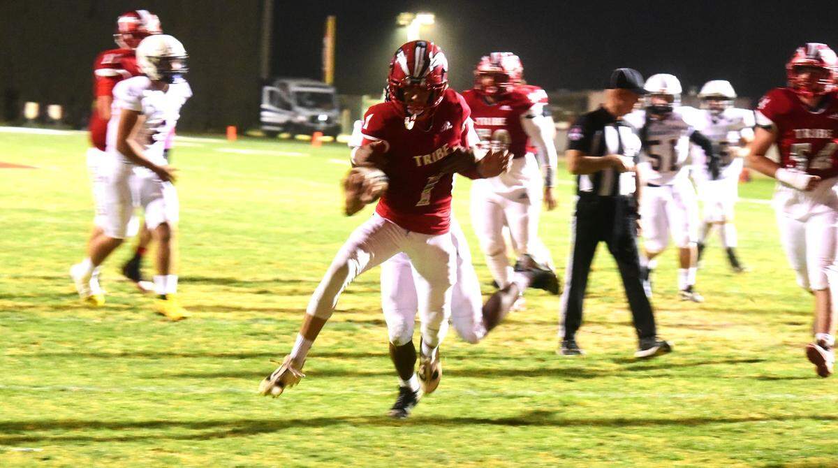 Chowchilla High senior quarterback Davian Stephenson (1) scores one of his five rushing touchdowns in the first quarter during the Tribe’s 54-20 victory over Minarets on Friday, Oct. 18, 2024 at Henry Massaro Stadium.