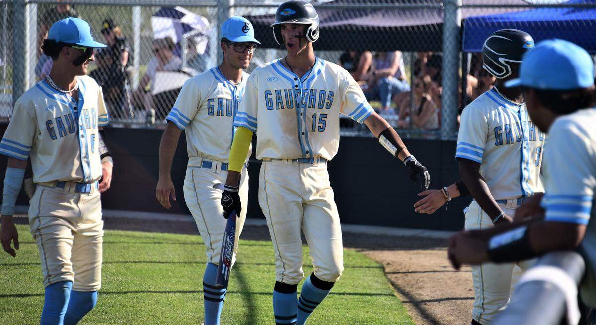 El Capitan High School senior Mitchell Hunter (15) is greeted by teammates after scoring a run during an 11-0 win over Escalon on Thursday, April 27, 2023 at El Capitan High School.