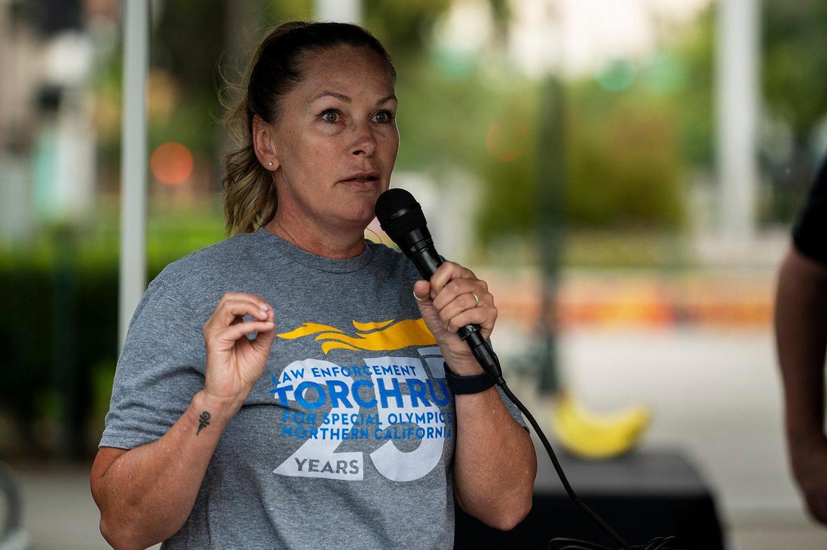 Merced police officer Krista Stokes speaks to participants prior to the Law Enforcement Torch Run for Special Olympics Northern California at Bob Hart Square in Merced, Calif., on Wednesday, June 22, 2022. This year marks the 25th anniversary of the Law Enforcement Torch Run for the Special Olympics Northern California. According to Stokes, she has been in charge of organizing the Merced County leg of the run for the past two years.
