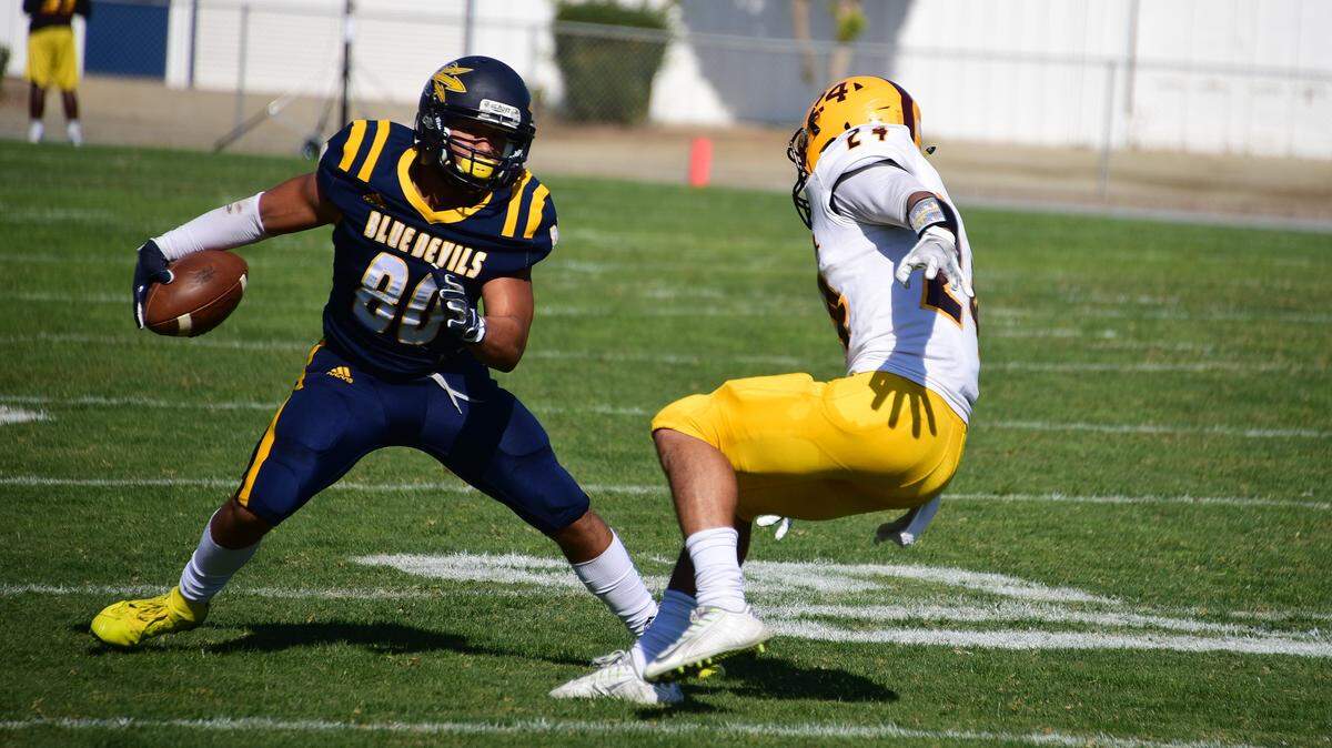 Merced College receiver Marcus Brady makes a move against a Hartnell defender during a game on Saturday, Oct. 26, 2019.