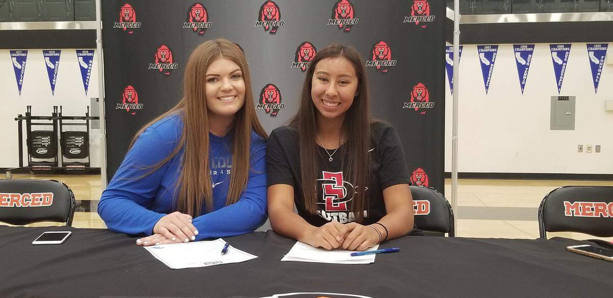 Merced High softball players Kat Arceo (left) and Jewels Perez signed their national letters of intent to play college softball. Arceo is headed to York College in Nebraska and Perez will play at San Diego State.