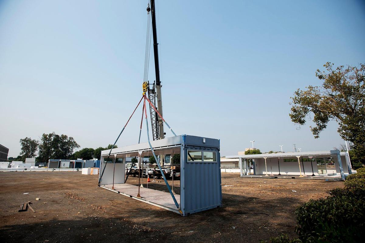 Construction workers move a modular unit with a crane near Merced County’s Navigation Center which is under construction at 1411 B Street in Merced, Calif., on Tuesday, Sept. 1, 2020. According to the county, the 15,000 square-foot facility will help address homelessness and will operate as a low-barrier emergency shelter option for those currently residing in public spaces and other places that are deemed not suitable for human habitation.